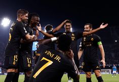 a group of men standing on top of a soccer field