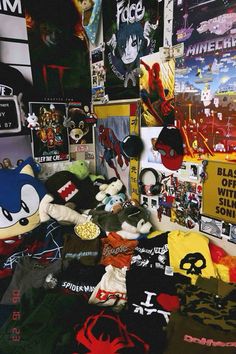 there are many t - shirts and other items on the floor in front of this wall