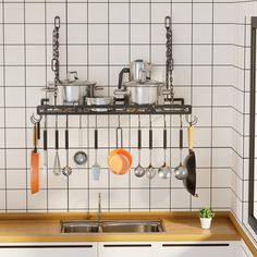 a kitchen with pots and pans hanging on the wall above the sink, next to a window