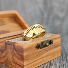 a wooden box with a baseball in it