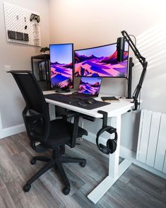 two computer monitors sitting on top of a white desk