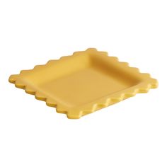 a yellow plastic tray with scalloped edges