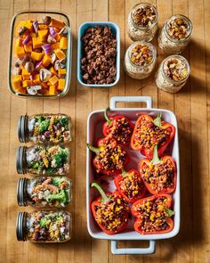 several containers filled with food sitting on top of a wooden table next to other foods