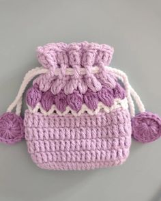 a crocheted bag with two handles and one handle is shown in light purple