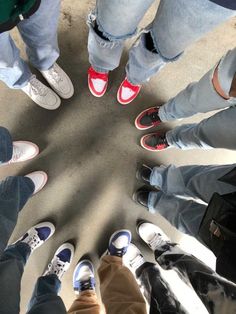 a group of people standing in a circle with their feet on each other's legs