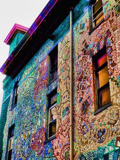 a multicolored building with lots of windows and graffiti on it's side