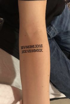 a person with a tattoo on their arm that reads, dox numerals