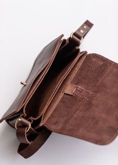 The Five Pocket Leather Crossbody Bag has a place for everything, with pockets inside for every use, including credit cards, your phone, and small loose items like earbuds and cords! is handcrafted in the USA, using American sourced full-grain leather! Your bag is unique containing natural variations in color that give it distinct beauty.This little piece is just the right size for some essentials and extras! It features 5 interior pockets, 4 card slots, and an 8 card capacity. Swing it over you Leather Belt Bag With Cell Phone Pocket As Gift, Brown Flap Bag With Smooth Grain For Daily Use, Leather Phone Bag With Card Slots For Everyday, Leather Phone Bag With Interior Card Slots For Everyday, Everyday Brown Saddle Bag With Phone Pocket, Everyday Brown Flap Bag With Smooth Grain, Brown Phone Bag With Interior Card Slots For Gift, Leather Phone Bag Perfect As A Gift, Leather Phone Bag With Card Slots As Gift