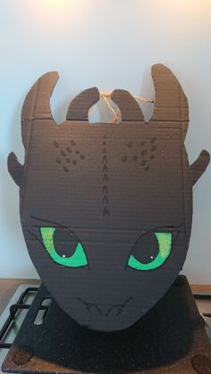 a cardboard cut out of a black cat with green eyes