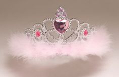 a tiara with pink feathers and a heart on the top, sitting in front of a white background