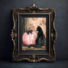 a black cat sitting next to a pink pumpkin in a gold frame on a wall