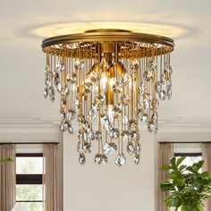 a living room filled with furniture and a chandelier hanging over the top of it