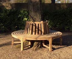 a wooden bench sitting next to a tree