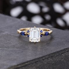 an emerald and blue sapphire engagement ring