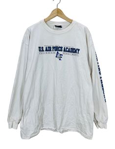 "Vintage sizes are different from modern sizes, often run much smaller, and differ from brand to brand. Please purchase based on measurements below and not based on tag size  DESCRIPTION This is a Vintage 90's USAFA Air Force Academy Athletics Department Distressed Long Sleeve T-Shirt. Fits like a XL (please see measurements below to ensure a proper fit). Great design! CONDITION Vintage Preowned Condition - shows signs of wear and fading due to age and normal use. There are lots of stains and some discolor at the underarms - distressed! Please see reference photos. MEASUREMENTS Underarm to Underarm: 24\" Top of Shoulder to Bottom Hem: 30.5\"  SHIPPING Item will be tightly folded. Please message us for International Shipping. International buyers are responsible for any import/duty fees the 90s Style Long Sleeve Pre-shrunk Top, 90s Long Sleeve Pre-shrunk Tops, Distressed Long Sleeve, Air Force Academy, Us Air Force, Shirt Fits, Long Sleeve T Shirt, Air Force, Long Sleeve Tshirt