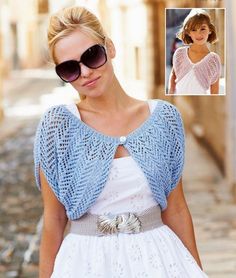 a woman in a white dress and sunglasses is wearing a blue knitted shrugr