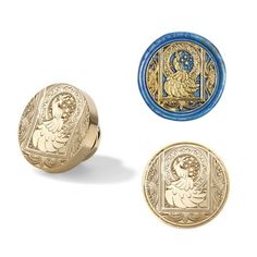 three gold and blue buttons with an image of a woman on the front, one in the