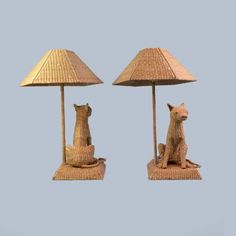 two lamps that have cats on them and one is sitting under a lamp shade with a cat figurine next to it