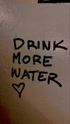 graffiti written on the wall says drink more water