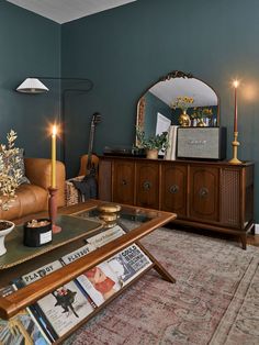 a living room filled with furniture and a christmas tree on top of a coffee table