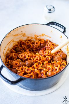 a large pot filled with pasta and meatballs