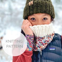 a woman wearing a knitted hat and scarf covers her face while she holds her hand to her mouth