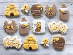 winnie the pooh cookies are decorated with frosting and icing to look like baby's first birthday