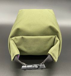 a small green bag sitting on top of a table