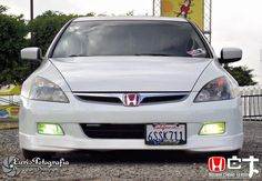 the front end of a white honda accord