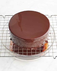 a chocolate cake sitting on top of a cooling rack