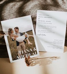 a couple holding each other in front of an open letter and photo on a table