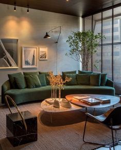 a living room filled with lots of furniture and decor on top of carpeted flooring