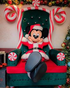 a mickey mouse sitting in a chair with candy canes