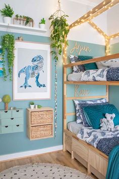 a bedroom decorated in blue and green with bunk beds, pillows and blankets on them