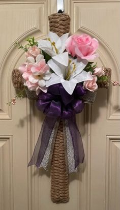 a door hanger decorated with flowers and ribbons