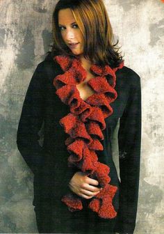 a woman wearing a black top and red scarf