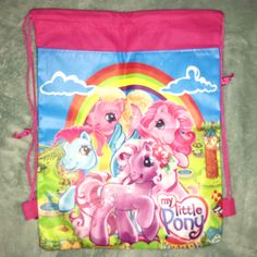 a pink pony drawsack bag with two ponies on it and a rainbow in the background