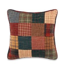 a multicolored patchwork pillow on a white background