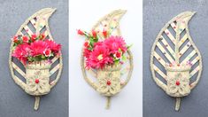 three different pictures of flowers in vases on the wall and hanging from metal hooks