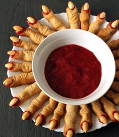 a white bowl filled with red sauce on top of a plate