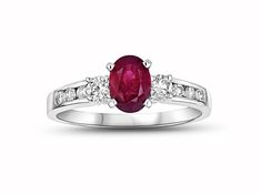 Ruby and Diamond Engagement Ring in 14k White Gold. This engagement ring has a 7x5mm oval Ruby in the center and has 0.40ctw of diamonds. White Gold Oval Rings With Side Stones, Oval Three Stone Ruby Ring With Diamonds, Oval Ruby Ring With Three Diamonds, Formal Oval Diamond Ring With Side Stones, Oval Diamond Ring With Side Stones For Promise, Oval Diamond Promise Ring With Side Stones, Oval Anniversary Rings With Side Stones, Oval Rings With Side Stones For Anniversary, Oval Diamond Ring With Side Stones In White Gold