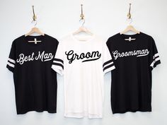 two black and white t - shirts hanging on a clothes hanger with the words best man, groomsmans printed on them