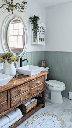 a bathroom with two round mirrors above the sink and wooden cabinet below, along with a rug on the floor