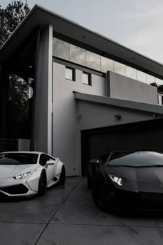 two cars are parked in front of a house