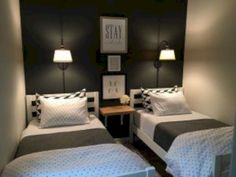 two twin beds in a small room with black and white decor