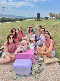 a group of women sitting at a picnic table