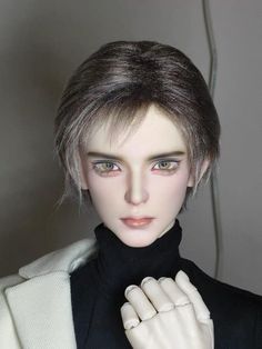 a close up of a mannequin head wearing a black turtle neck sweater and white gloves