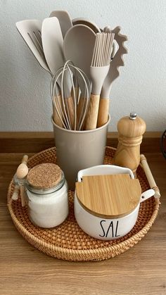 kitchen utensils are arranged in a basket on a table