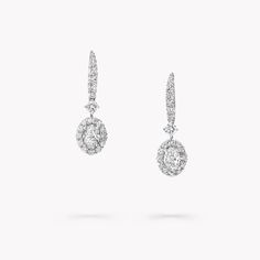 A gleaming pavé diamond halo frames two elegant centre stones in our Icon earrings in white gold, enhancing the captivating play of light that emanates from deep within the oval diamonds. Suspended from graceful pavé clips, the diamond detailing is designed to scintillate with the wearer's every movement. Named after the famous Icon diamond – a 90.97 carat round brilliant diamond that was cut and polished by Graff in 2000 – the Icon collection celebrates the incomparable beauty of one of Mother’ Oval Diamond Earring, Graff Diamonds, Icon Jewelry, Round Diamond Pendant, Round Diamond Earrings, Pave Diamond Earrings, Diamond Earrings Studs Round, Yellow Engagement Rings, Mini Earrings