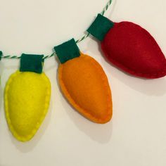 three felt christmas lights hanging on a string